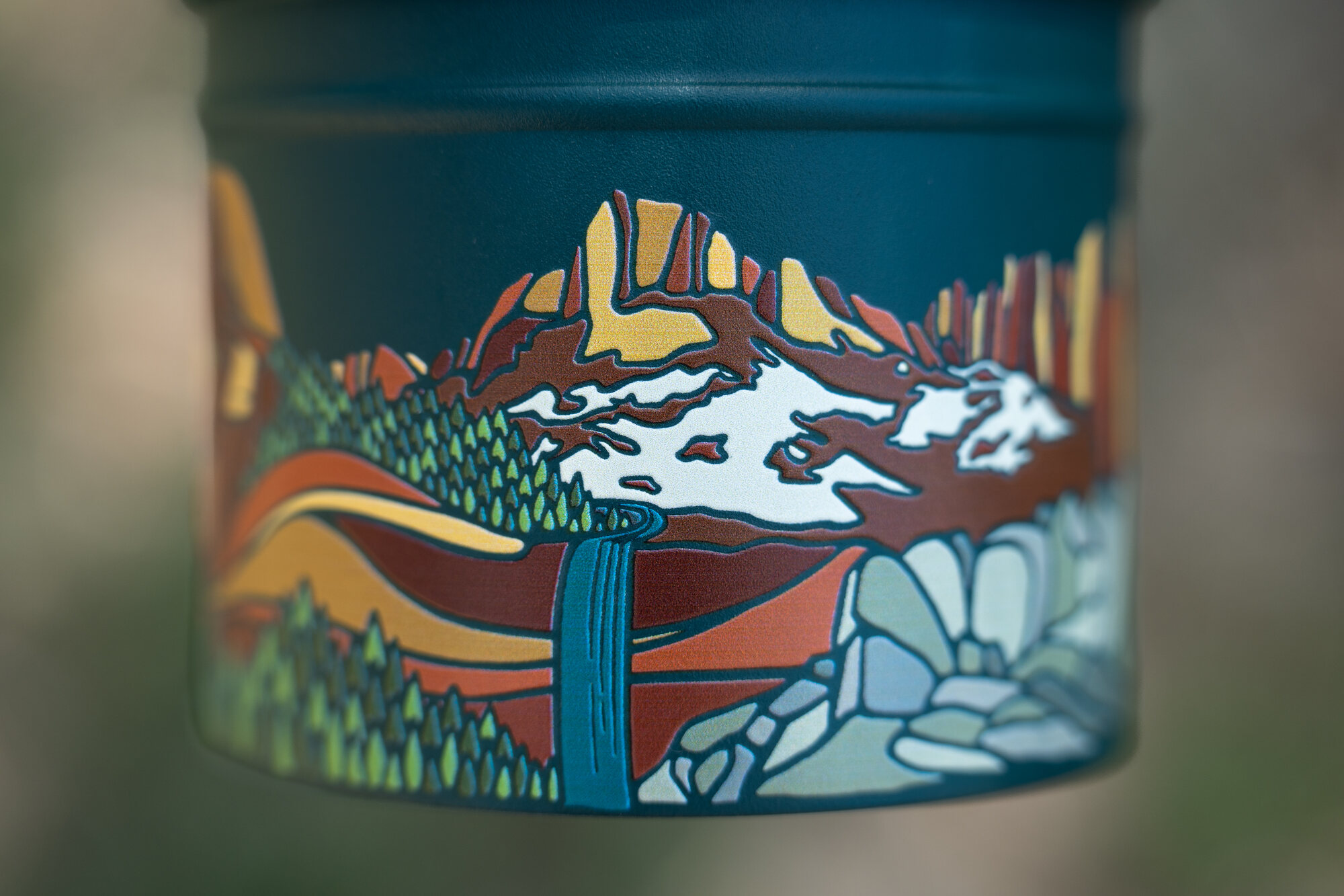 Detail of the illustrated mountain and waterfall artwork on the base of a Hibear flask