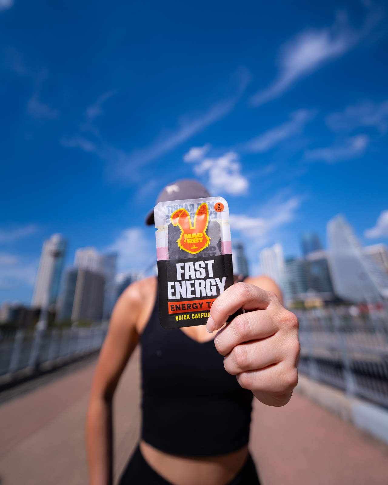 Mad Rbt Fast Energy tape held up against the city skyline