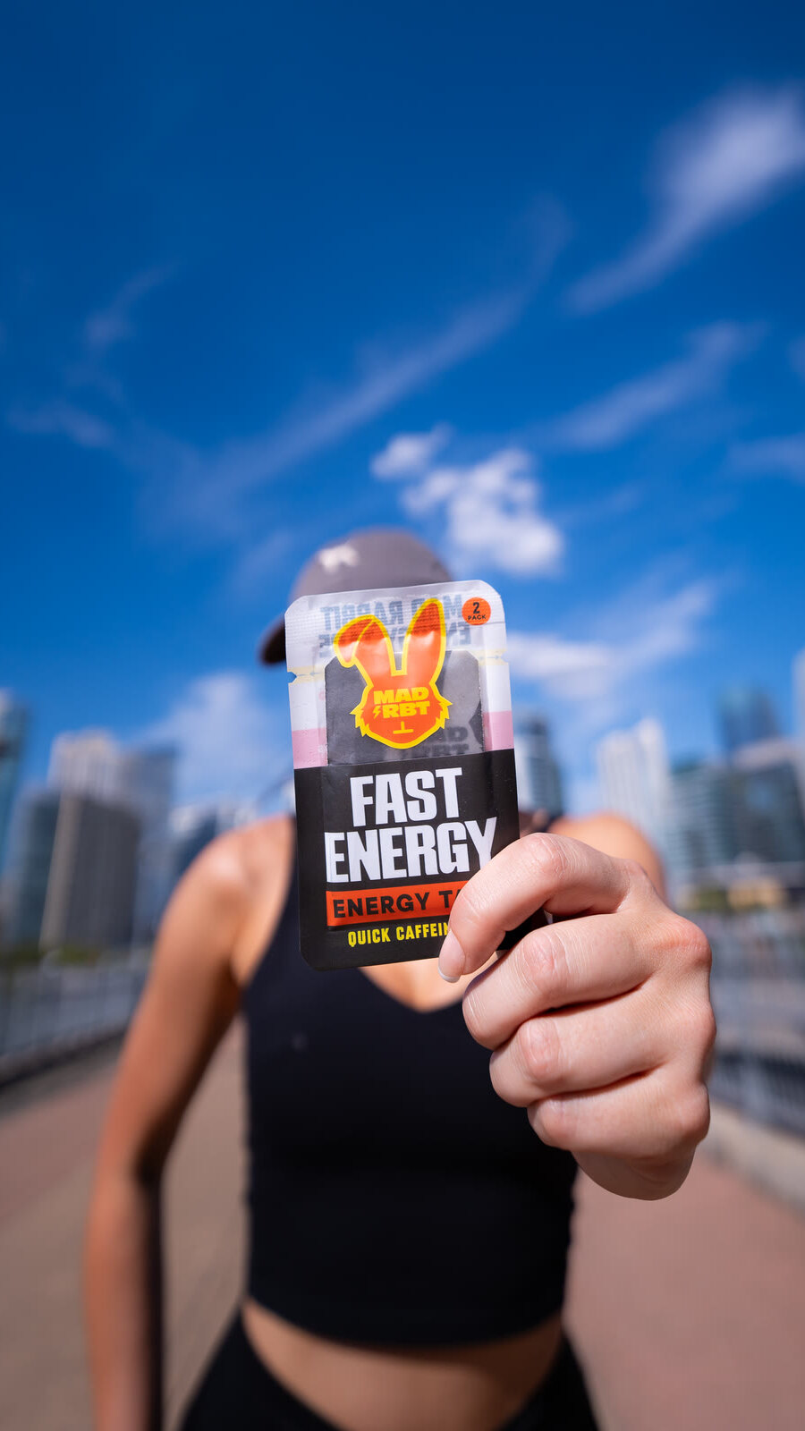 Mad Rbt Fast Energy tape held up against the city skyline